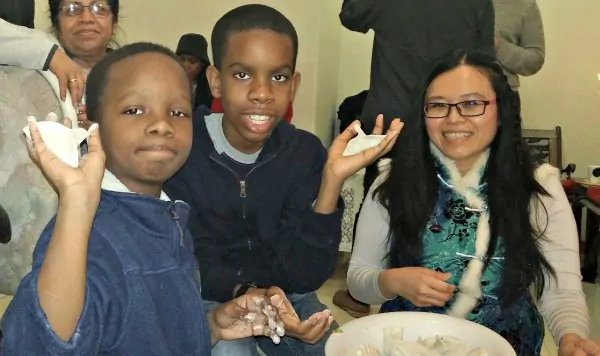 my sons making dumplings at a Chinese New Year party